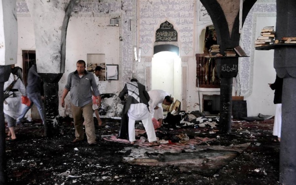 People clear a mosque after a suicide bomb attack in Sanaa, Yemen, March 20, 2015 