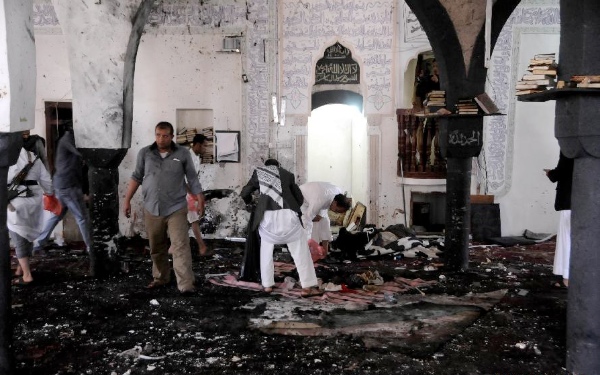 People clear a mosque after a suicide bomb attack in Sanaa, Yemen, March 20, 2015