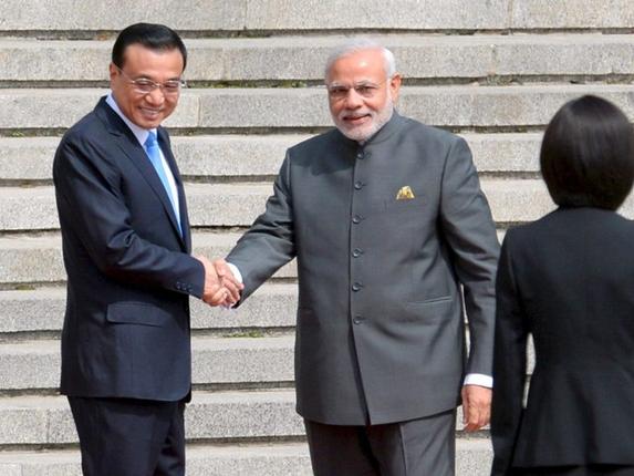 Prime Minister Narendra Modi and Chinese Premier Li Keqiang (L) shake hands during a welcome ceremony outside the Great Hall of the People, in Beijing on Friday.