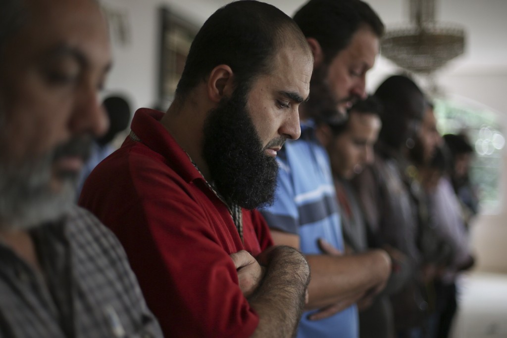 In this May 15, 2015 photo, Syrian refugee Abdulhannan Mouhammed, second from left, attends Friday prayer at a mosque in Sao Paulo, Brazil. Two years after the Syrian civil war broke out, Brazil adopted measures that made it easier for Syrians to be granted refugee status. (Andre Penner/Associated Press)