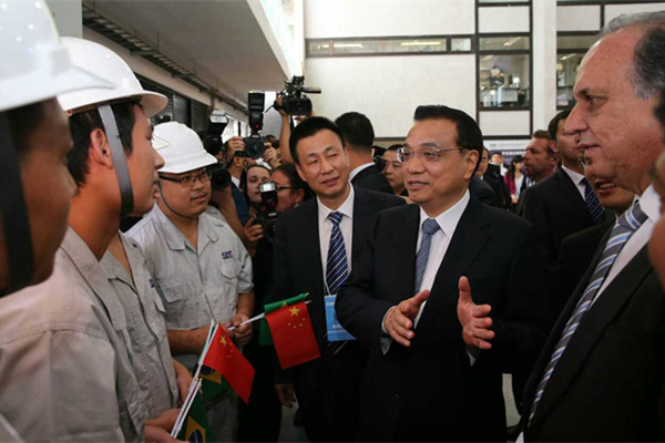 Premier Li Keqiang meets workers from China's CNR Corp on Wednesday.[Photo/english.gov.cn]