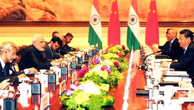 In this handout photograph taken and released by The Indian Press Information Bureau (PIB), Prime Minister Narendra Modi leads his delegation in talks with Chinese President Xi Jinping at The Shaanxi Guest House in Xi’an.