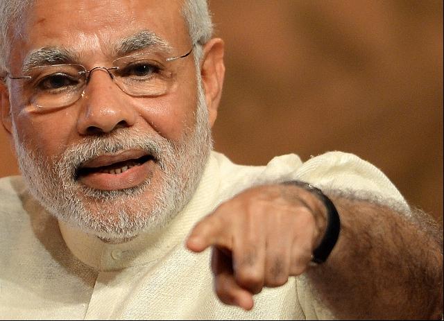 Indian Prime Minister Narendra Modi gestures as he speaks during the inauguration of a conference on Financial Inclusion in Mumbai on April 2, 2015. The conference was organised on the occasion of completion of 80 years of the Reserve Bank of India (Photo by Punit Paranjpe/AFP/Getty Images)