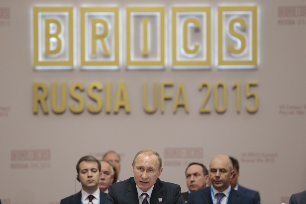 Russia's President Vladimir Putin (C) speaks during a working session at the 7th BRICS summit in Ufa on July 9, 2015. Leaders of the BRICS (Brazil, Russia, India, China and South Africa) group of emerging powers gathered in Ufa on Thursday to discuss regional and global issues, including the Syria conflict, threat of the Islamic State group, the situation in Greece and Iran's nuclear programme. AFP PHOTO / POOL / IVAN SEKRETAREV