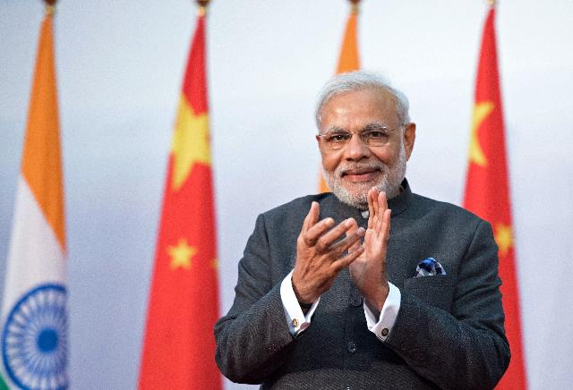 India’s Prime Minister Narendra Modi applauds during the opening ceremony of the Centre for Gandhian and Indian Studies at Fudan University in Shanghai on May 16. (JOHANNES EISELE/AFP/Getty Images)