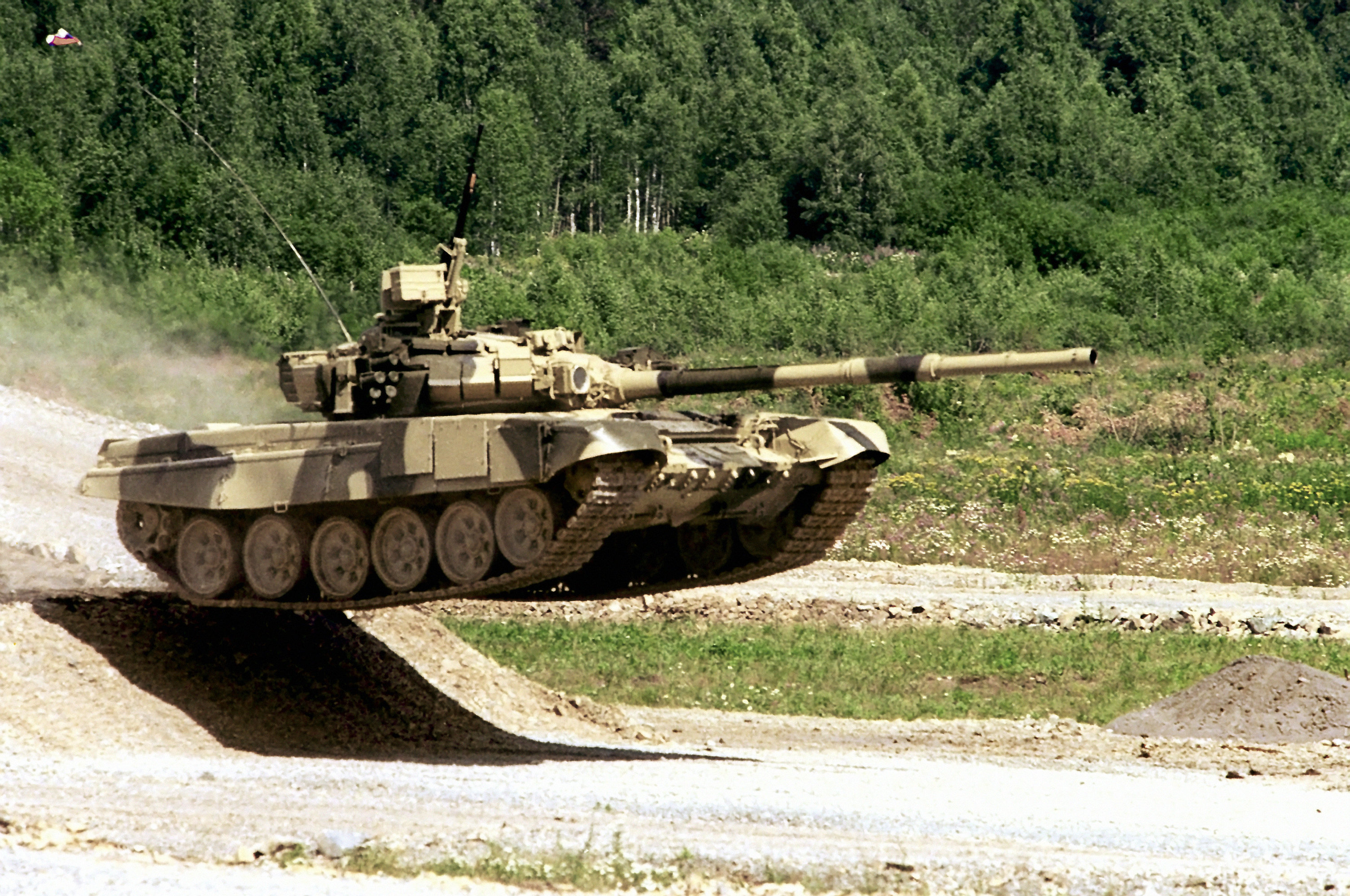 A T-90S performing a sick jump during a military exercise.
