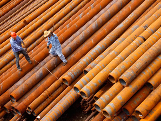 Workers arrange the steel pipes at a factory in Huaibei, east China's Anhui province.STR/AFP/Getty Images.
