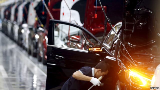 FILE - An employee works on an assembly line producing Mercedes-Benz cars at a factory of Beijing Benz Automotive Co. in Beijing, Aug. 31, 2015.