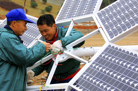 Technicians assemble a solar-powered street lamp in Jiangxi province, China [Xinhua]