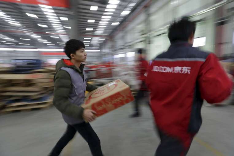 Workers at a logistics centre in Langfang on Nov 10. PHOTO: REUTERS