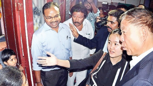 Chinese Vice Minister for International Department of Communist Party of China (CPC) Chen Fengxiang interacting with a family at Sikhamani Centre in Vijayawada on Monday | Express PHoto