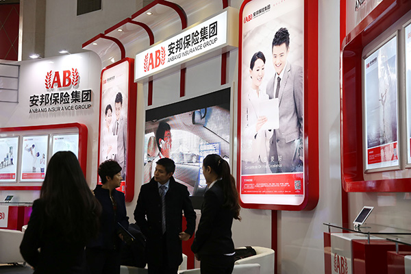Visitors at the Anbang Insurance Group Co Ltd booth at a financial industry expo in Beijing. [Photo provided to China Daily]