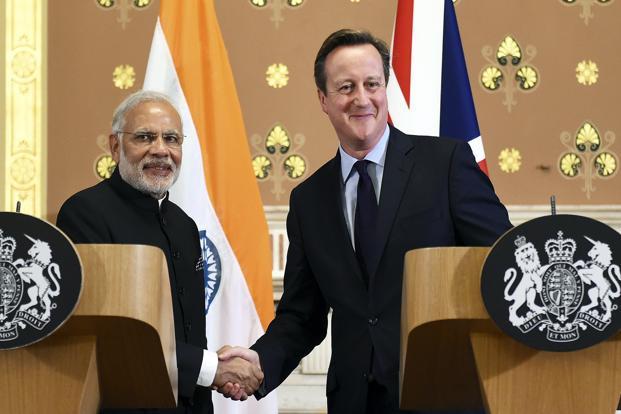 Modi shakes hands with Cameron after a joint news conference at the Foreign Office in London on Thursday. Photo: Reuters