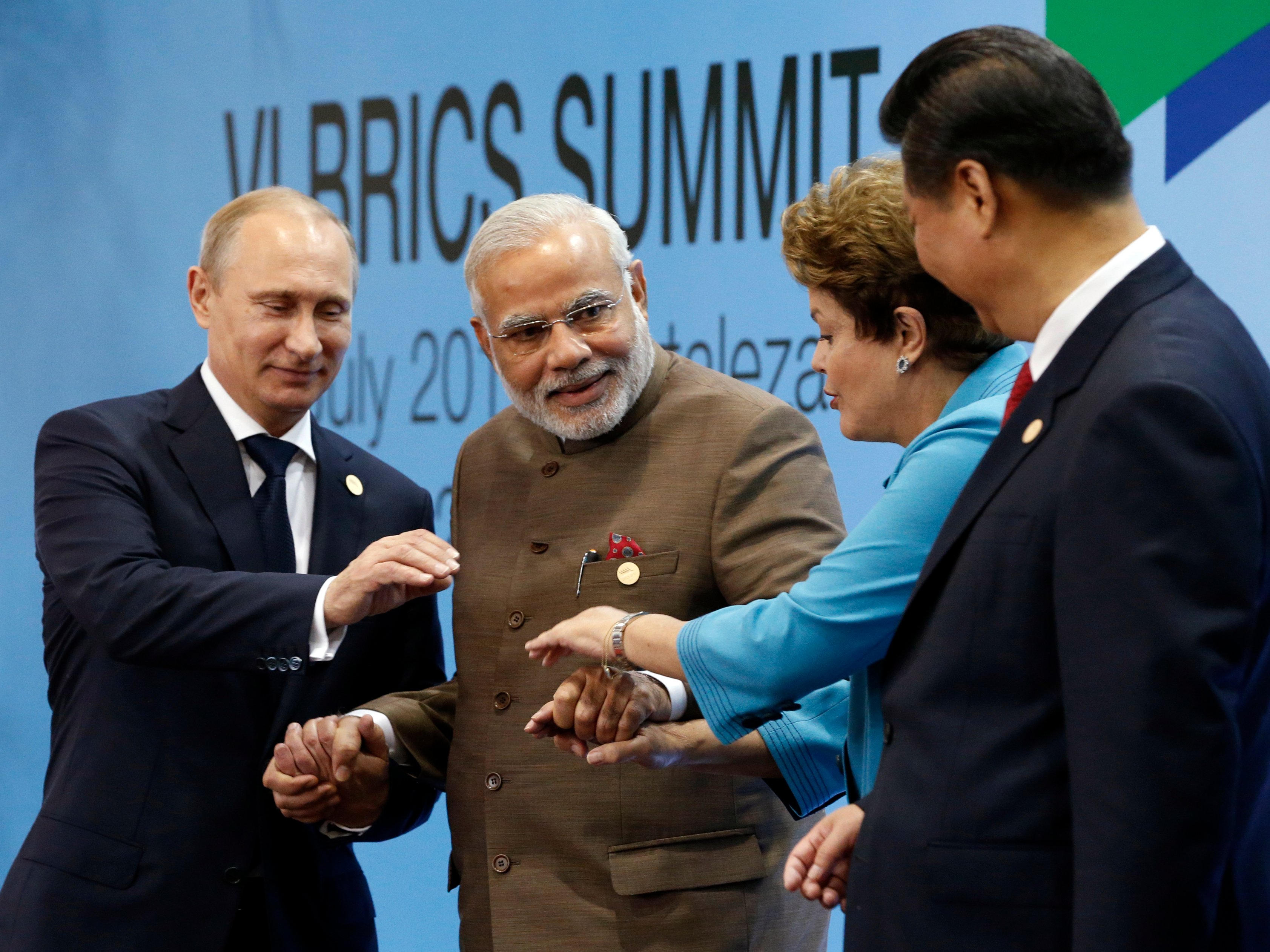 Russia's President Vladimir Putin, India's Prime Minister Narendra Modi, Brazil's President Dilma Rousseff and China's President Xi Jinping pose for a group picture during the VI BRICS Summit in Fortaleza July 15, 2014.