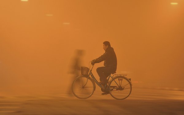 A cyclist in Fuyang, China, on Monday in the worst recorded smog of the year. China Network/Reuters