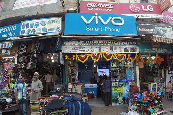Chinese smartphone logo of vivo and Gionee on advertising billboards above an electronics store in New Delhi, India.