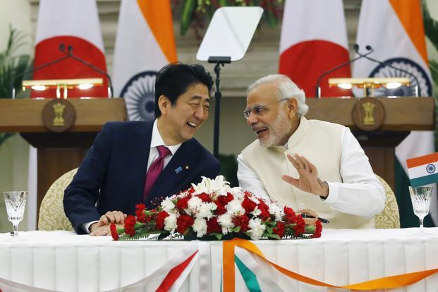 Japan’s PM Shinzo Abe (left) and Prime Minister Narendra Modi shares a moment during the signing of agreement at Hyderabad House in New Delhi on 12 December. Photo: Reuters