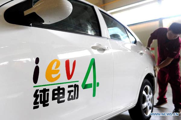 A worker checks a pure electric car at a workshop in Jianghuai Automobile Co Ltd in Hefei, capital of East China's Anhui province, Aug 19, 2014. © Photo/Xinhua