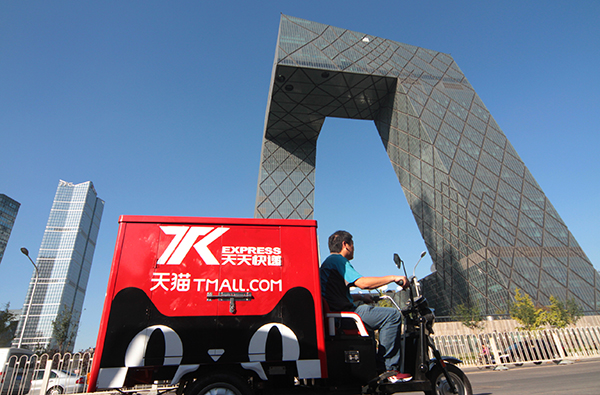 A delivery cart with the logo of Tmall.com, Alibaba's B2C platform, passes the CCTV building in Beijing. © Wu Changqing/China Daily