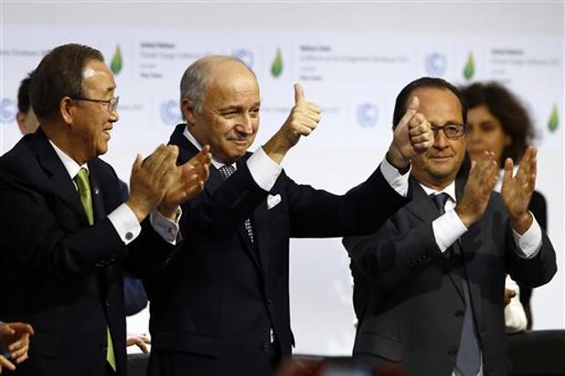 French president Francois Hollande, French foreign minister Laurent Fabius and United Nations secretary general Ban Ki-moon after the final conference in Paris on Saturday. Photo: AP