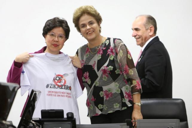 World Health Organization Director-General Chan receives a T-shirt from Brazil's President Rousseff during their meeting at the Planalto Palace in Brasilia