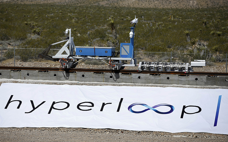 A recovery vehicle moves a sled down a track after a test of a Hyperloop One propulsion system, Wednesday, May 11, 2016, in North Las Vegas, Nev. The startup company opened its test site outside of Las Vegas for the first public demonstration of technology for a super-speed, tube based transportation system. (AP Photo/John Locher)