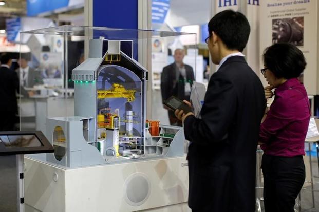 A file photo of visitors looking at a nuclear power plant station model by Westinghouse at an event. Photo: Reuters