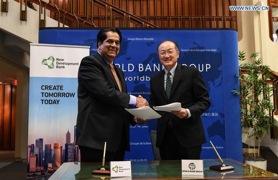 World Bank Group President Jim Yong Kim (R) and New Development Bank President K.V. Kamath shake hands after signing a memorandum in Washington D.C., the United States, Sept. 9, 2016. World Bank Group and the New Development Bank (NDB) set up by the BRICS nations on Friday signed a memorandum of understanding to strengthen their cooperation in addressing global infrastructure needs.