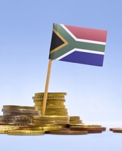 Flag of South Africa in a mixed stack of european coins and a blue background.(series)